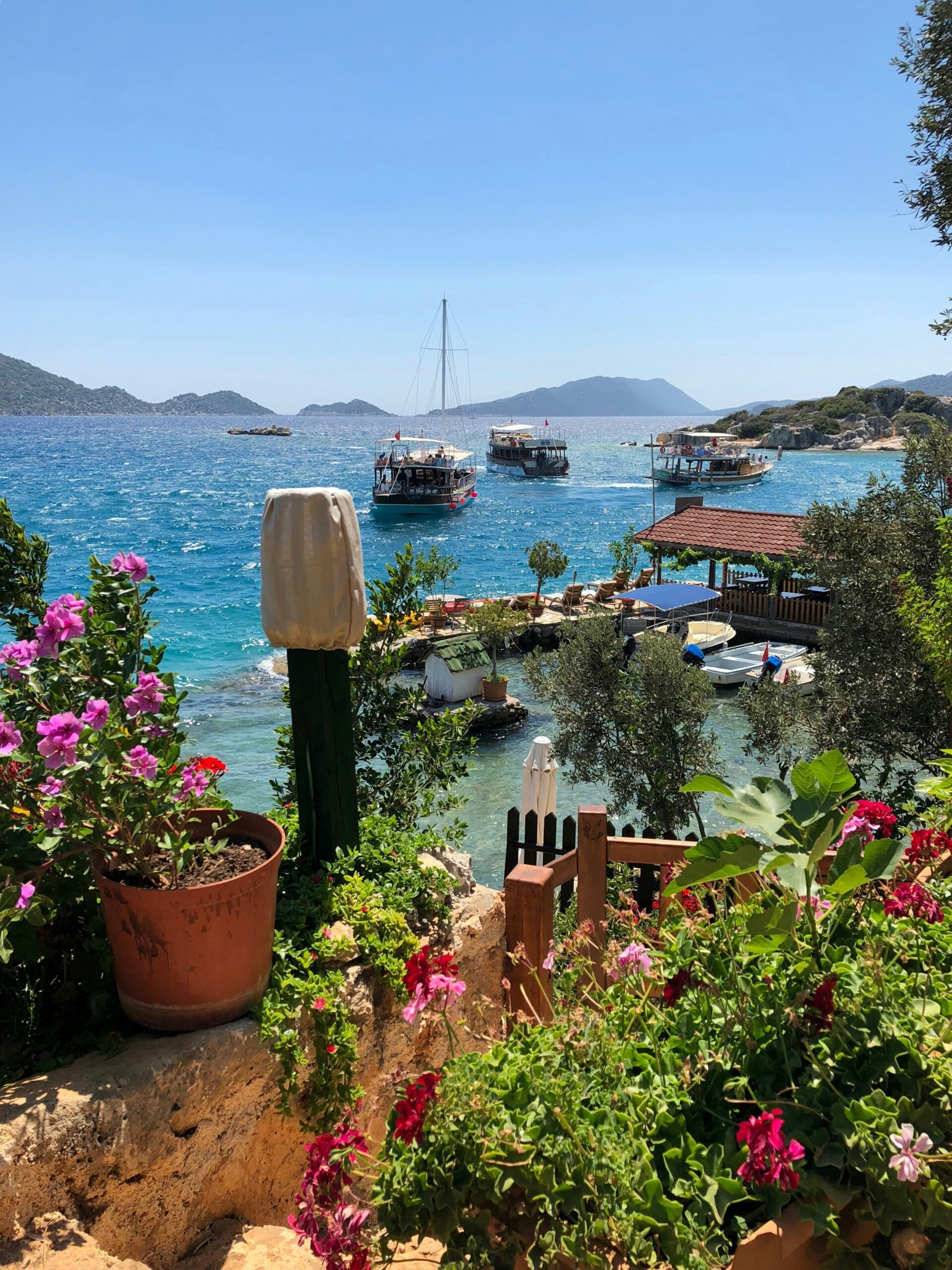 Flowers and homes above the waterway in Antalya.