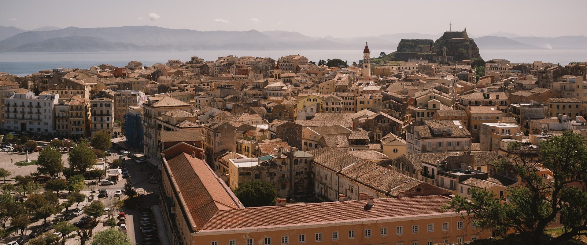 Aerial view of terracotta buildings in Corfu town.
