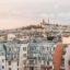 View of apartments buildings in paris, with Monmartre on the hill in the distance.