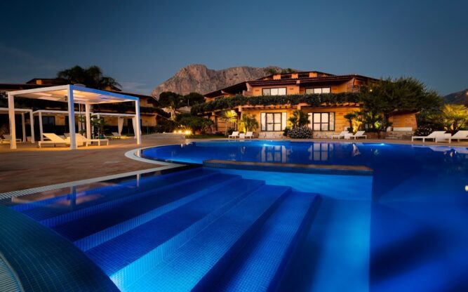 The large Magaggiari Resort pool in front of the resort building near Palermo Airport
