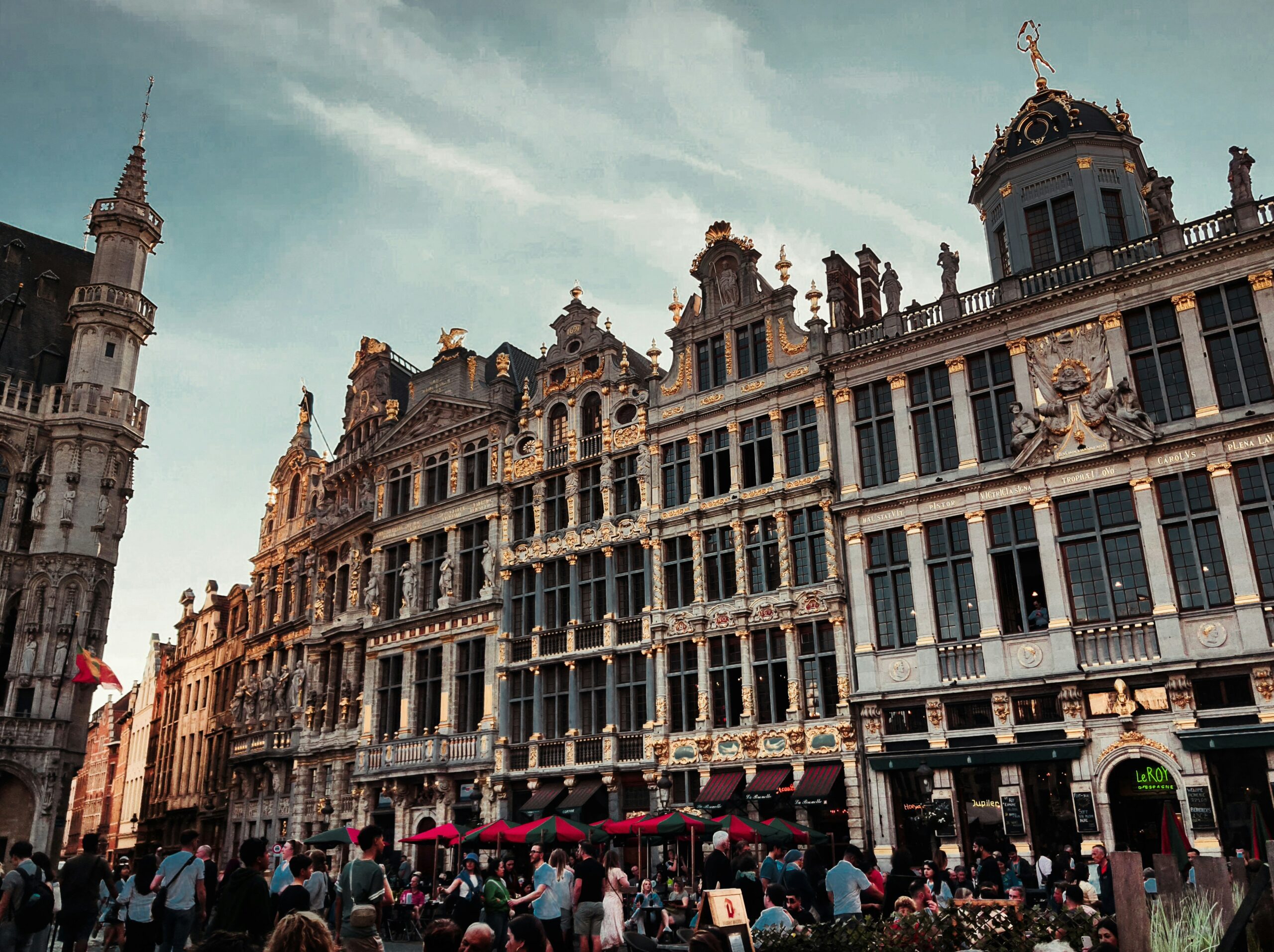Grand-Place in Brussels filled with people and beautiful ornate buildings.