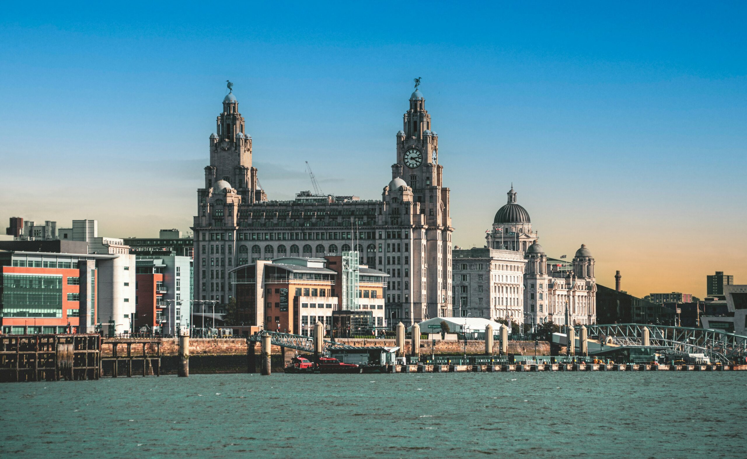 A view of the River Mersey with Liverpool city center in the background.