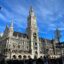 View of Munich Cathedral in Munich city center, with blue cloudy skies above.