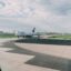 view out the window of a plane of another plane taxing to a gate