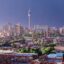 A view of Johannesburg City on a sunny day with a single tower dominating the skyline.