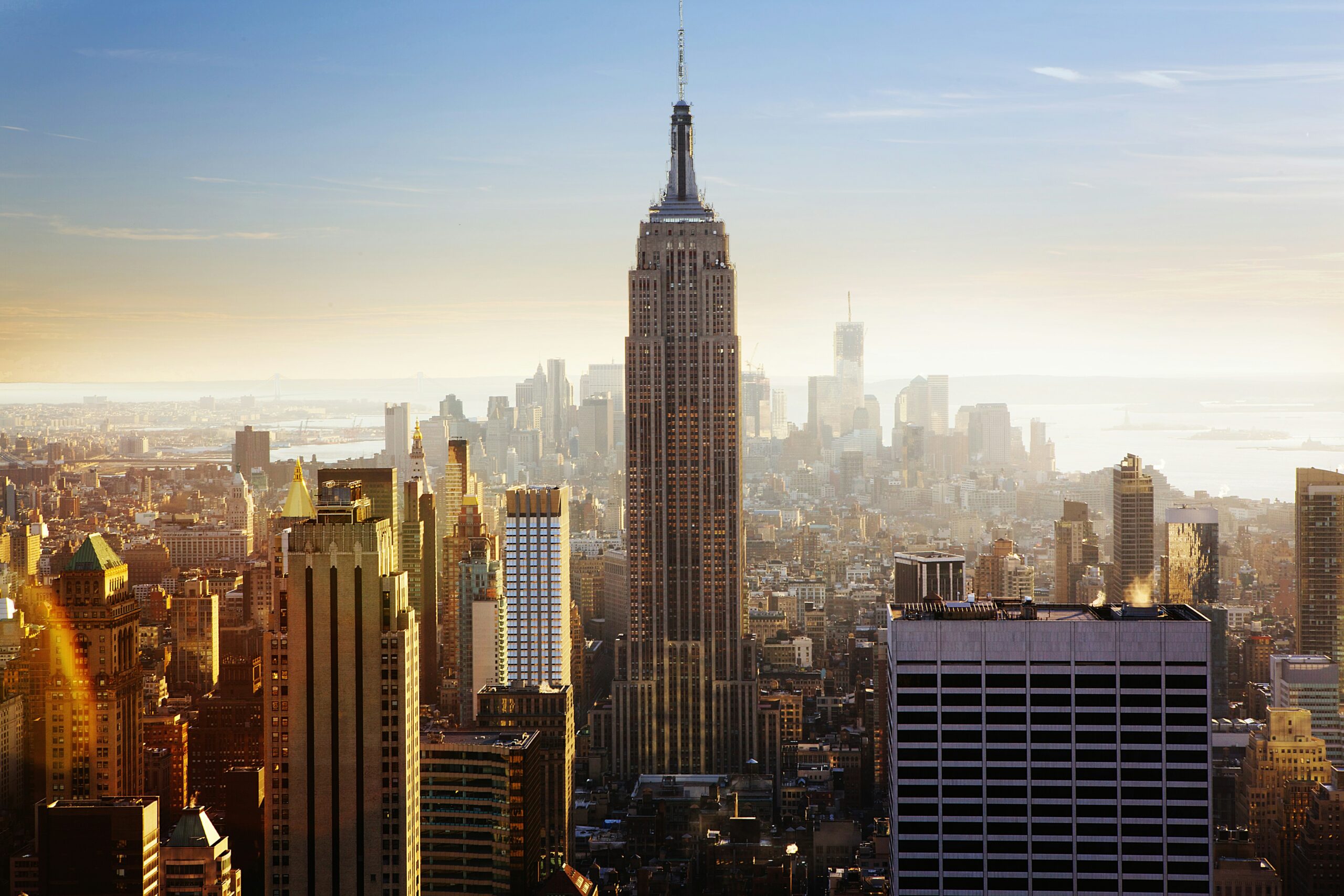 buildings of Manhattan as seen through a light fog under a blue sky