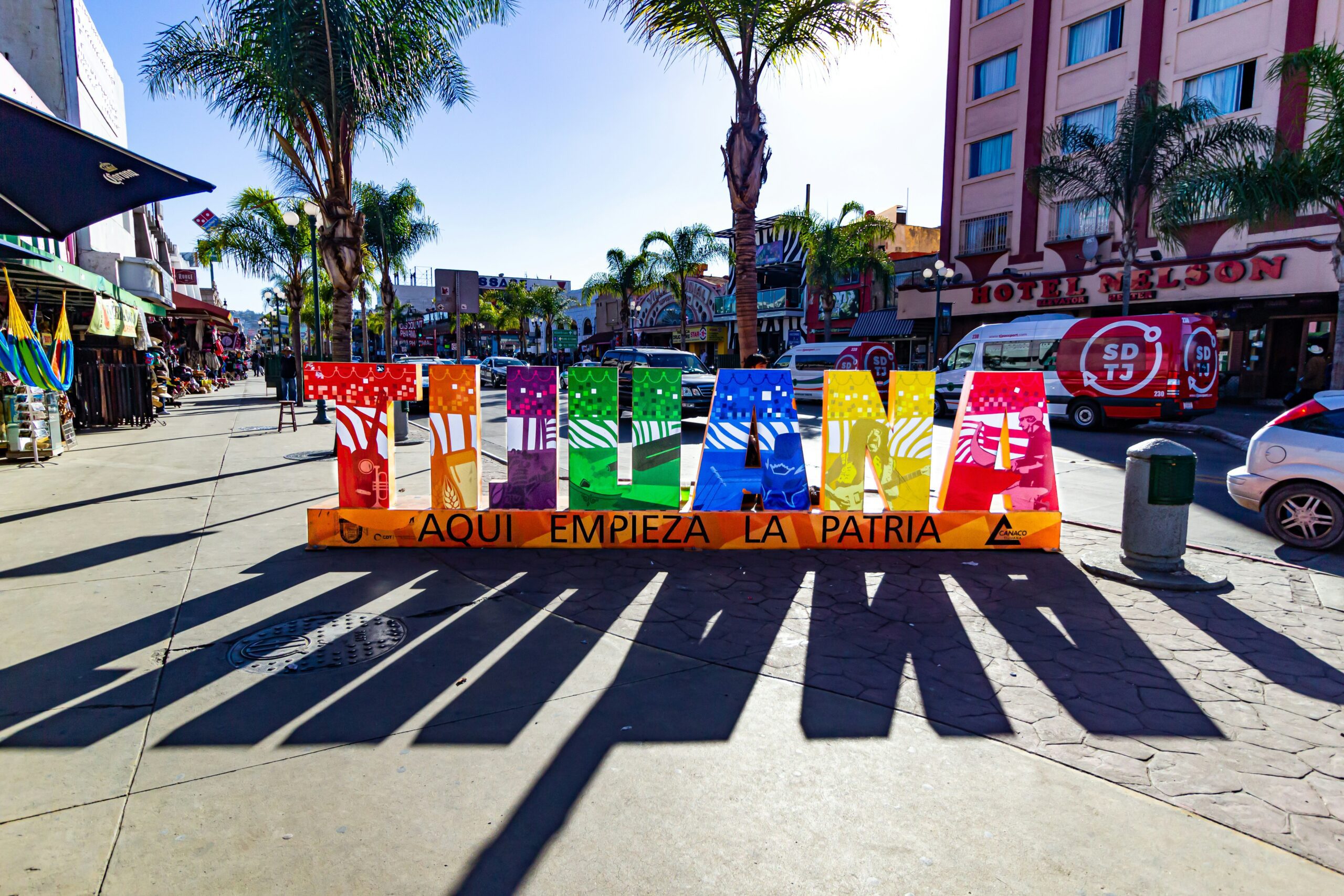 colorful Tijuana sign under a bright sun with a shadow