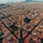 Aerial view of Barcelona city, with buildings in neat rows and blue skies above.
