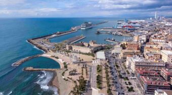 Aerial view of Civitavecchia Port, with a large body of water to the left, and a cruise ship in port.