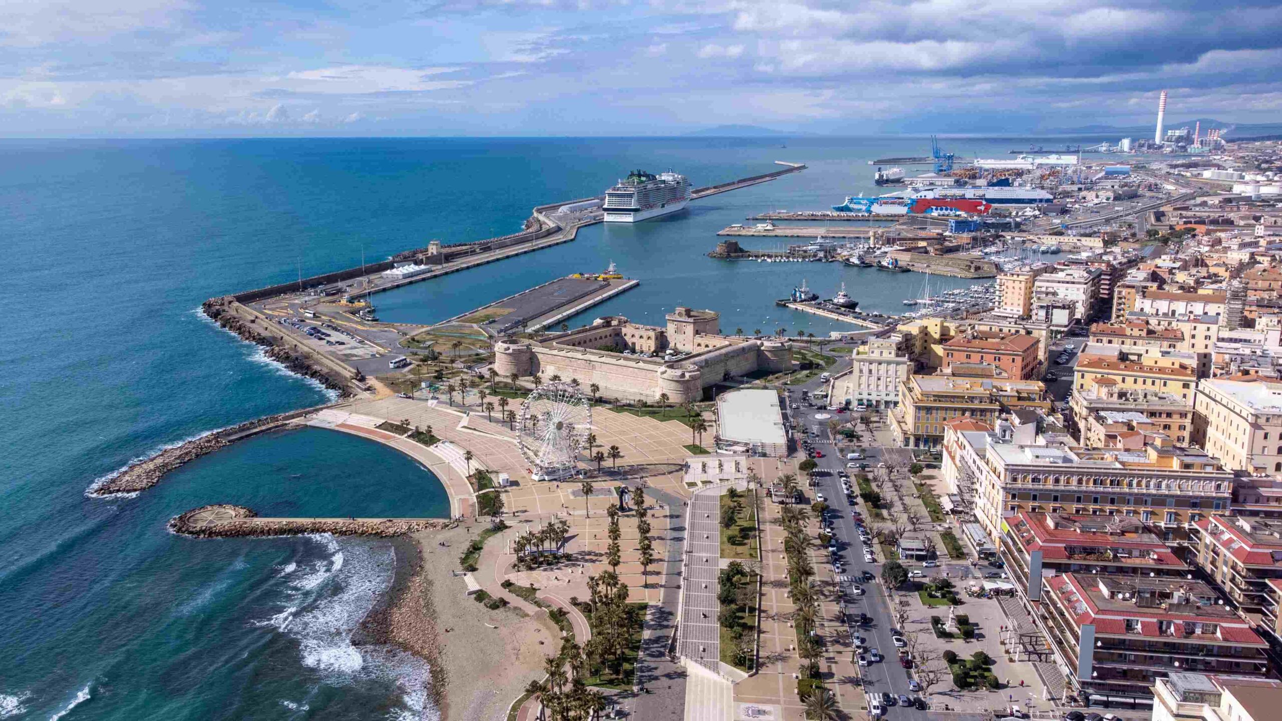 Aerial view of Civitavecchia Port, with a large body of water to the left, and 