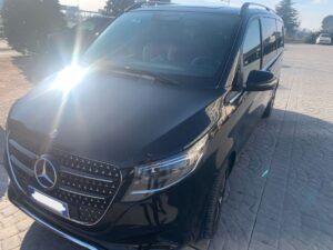 Welcome Pickups minivan - Rome Airport A black Rome Airport transfer minivan parked outside.