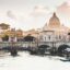 View of a bridge over a body of water in central Rome, with historical buildings in the background.
