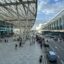view along the sidewalk of Cairo Airport's beautiful outdoor pickup area lined with windows and a large overhang cover