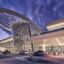 view outside iconic Orlando Airport at dusk under a purple sky
