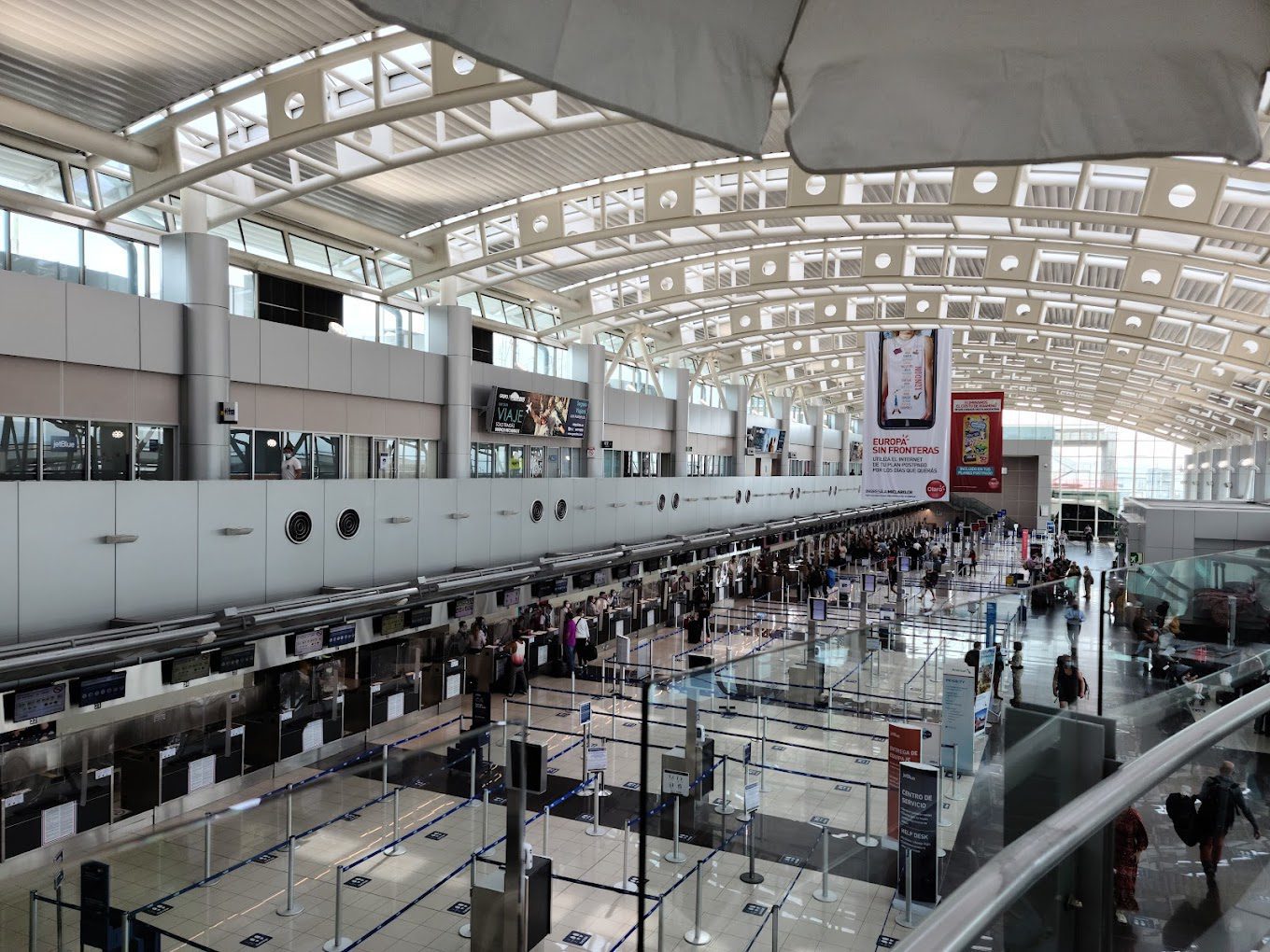 indoor view looking down on lines and barriers in an airport