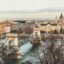 View of a bridge over a river, with Budapest city center in the background.