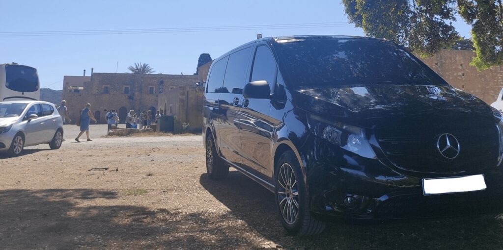 A black Crete Airport Taxi (Minivan)