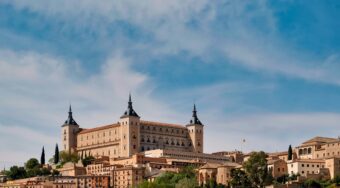 A large rectangular castle built on top of a hill in Toledo.
