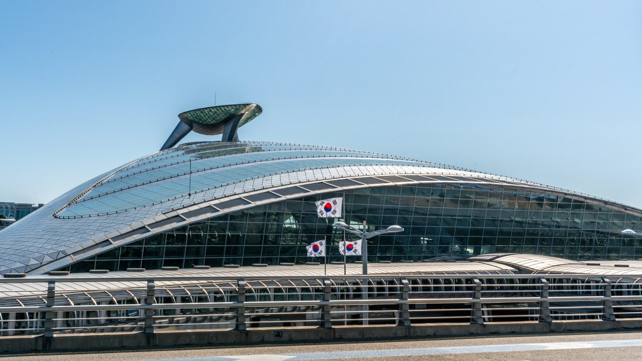 Incheon international Airport terminal building exterior view of AREX train station and Korean flags in Seoul South Korea