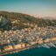 A scenic aerial view of Zakynthos town at sunset, with hillside homes, a bustling marina, and calm Ionian waters. Just a short drive from here lies Zakynthos Airport, the island’s main hub for domestic and international arrivals.