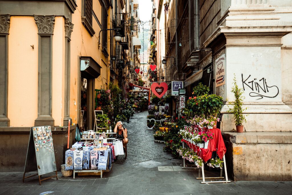 Narrow street and vendor in Naples, Italy