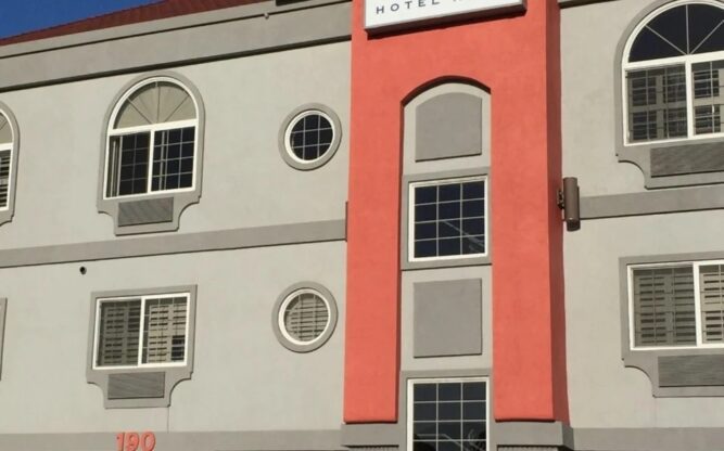 The external view of the white and coral-colored Auro Hotel near SFO