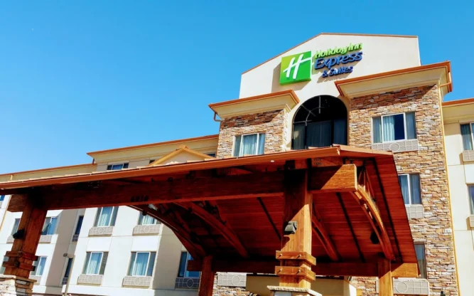 The arched wooden entrance to the Holiday Inn Express & Suites Hotel near Denver Airport.