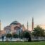 View of the Hagia Sophia at sunset with manicured gardens and minarets in the foreground, capturing a peaceful moment in the historic heart of Istanbul—just a short Istanbul taxi ride from the city’s main tourist districts.
