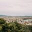 Panoramic view of Palma de Mallorca’s cityscape and marina under a cloudy sky, as seen from a hillside. A taxi from Mallorca Airport offers direct access to this scenic Mediterranean destination.