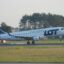 a Polish Airlines plane taking off from the runway