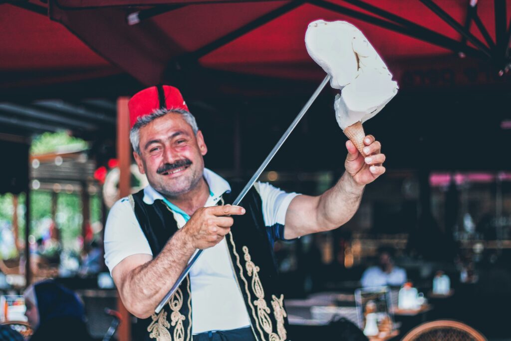 Man in traditional uniform serving Turkish ice cream