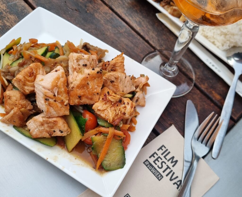 A plate of food next to a napkin that says film festival