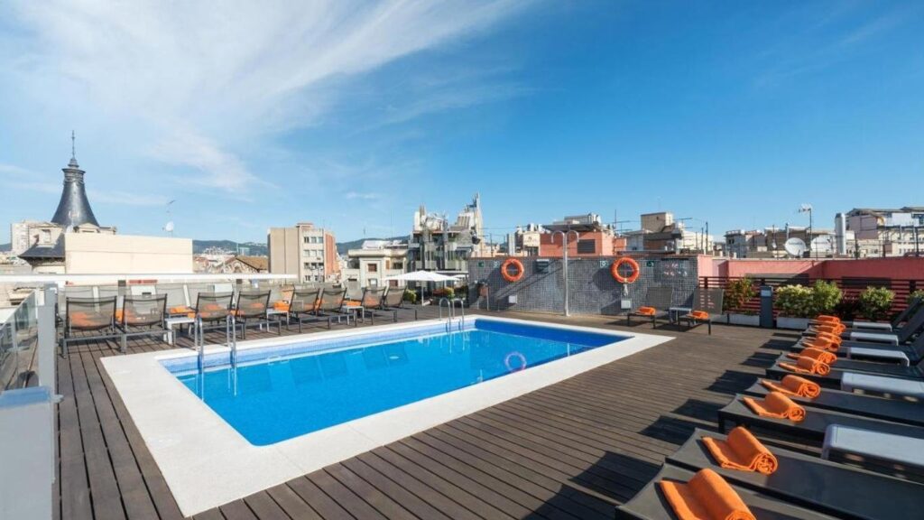 Sunny day, the rooftop pool at Hotel Jazz overlooking Barcelona. 