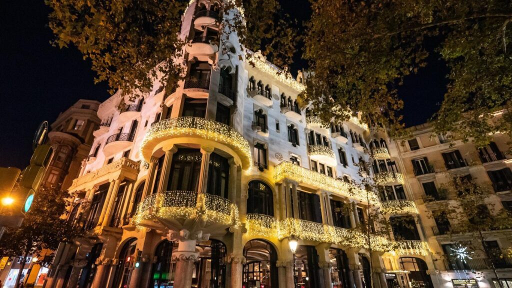 Hotel Casa Fuster at night, all windows lit up.