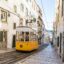 yellow trolley going up a city street