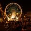 A Lisbon Christmas market with lots of glowing lights and a large ferris wheel.