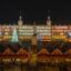 A Madrid Christmas market at night time. Many wooden stalls and christmas lights.