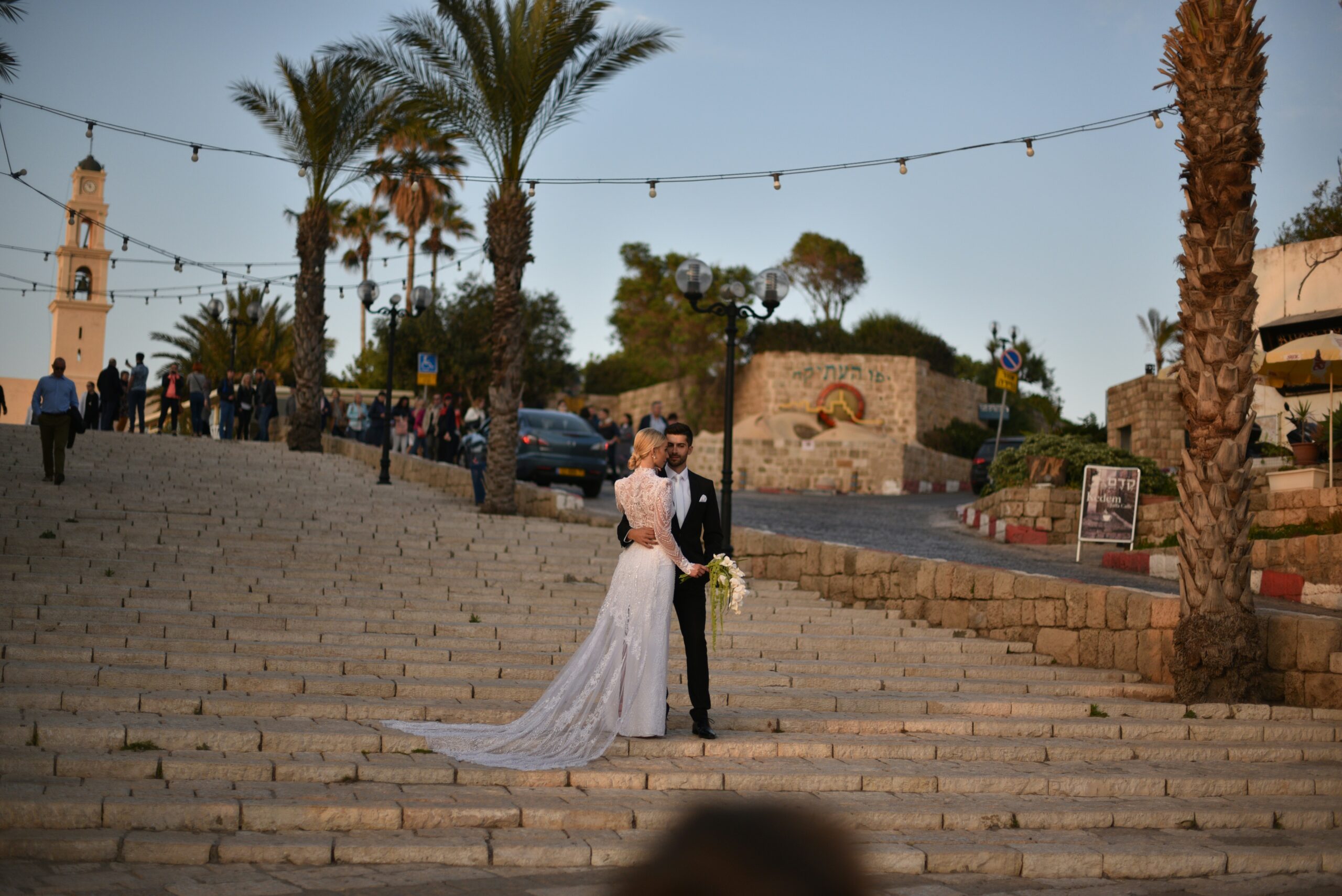 Bride and groom on the steps in Malta at golden hour.