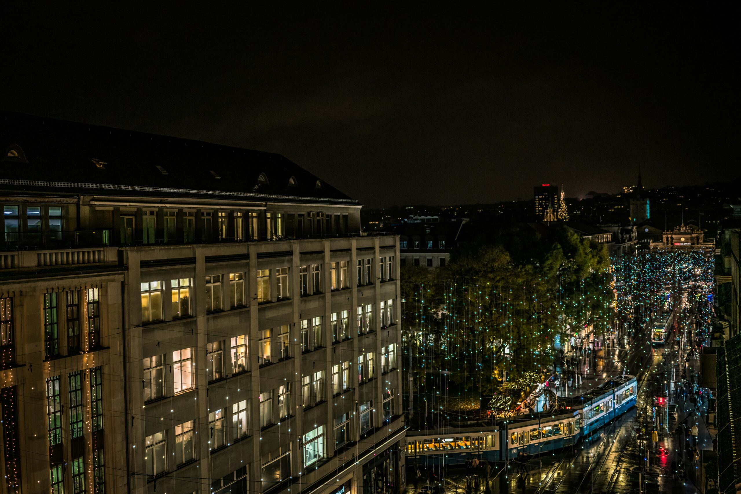 An street illuminated with Christmas lights