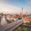 Aerial sunset view of Berlin city skyline and the Spree River, a top destination for travelers booking a Berlin airport taxi to Alexanderplatz.