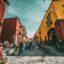 Vibrant street in San Miguel de Allende, Mexico, with colorful colonial buildings and local vendors, a must-visit for travelers booking a Mexico airport taxi.