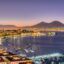Private airport transfer in Naples with a panoramic sunset view of Mount Vesuvius and the Gulf of Naples