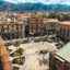 High-angle view of a historic square in Palermo, Sicily, with classic architecture and mountains in the background, a top location for travelers booking a Palermo Airport taxi.