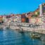 Colorful historic houses of Ribeira district in Porto along the Douro River, a popular spot for travelers taking a Porto Airport taxi to the city center.