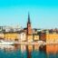 Scenic waterfront view of Stockholm's historic Gamla Stan and Riddarholmen Church, a primary destination for travelers booking a Stockholm airport taxi to the city center