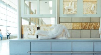 Ancient Greek marble sculptures and Parthenon frieze fragments displayed inside the Acropolis Museum, Athens