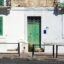 Malta Sliema street with traditional house and green shutters near Malta Airport route