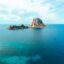 Ibiza coastline with rocky island and turquoise sea near Ibiza Airport