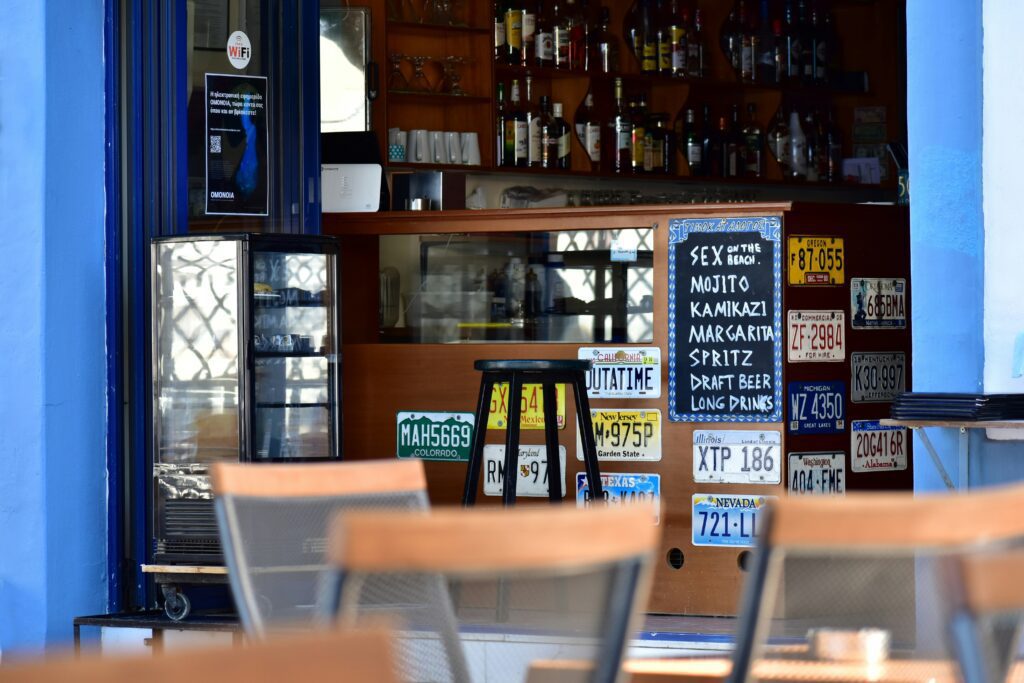 Tourist bar in Athens with a cocktail menu and American license plate decorations near Omonia Square