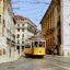 Yellow tram 25 passing through Praça do Comércio in the historic city center of Lisbon, Portugal